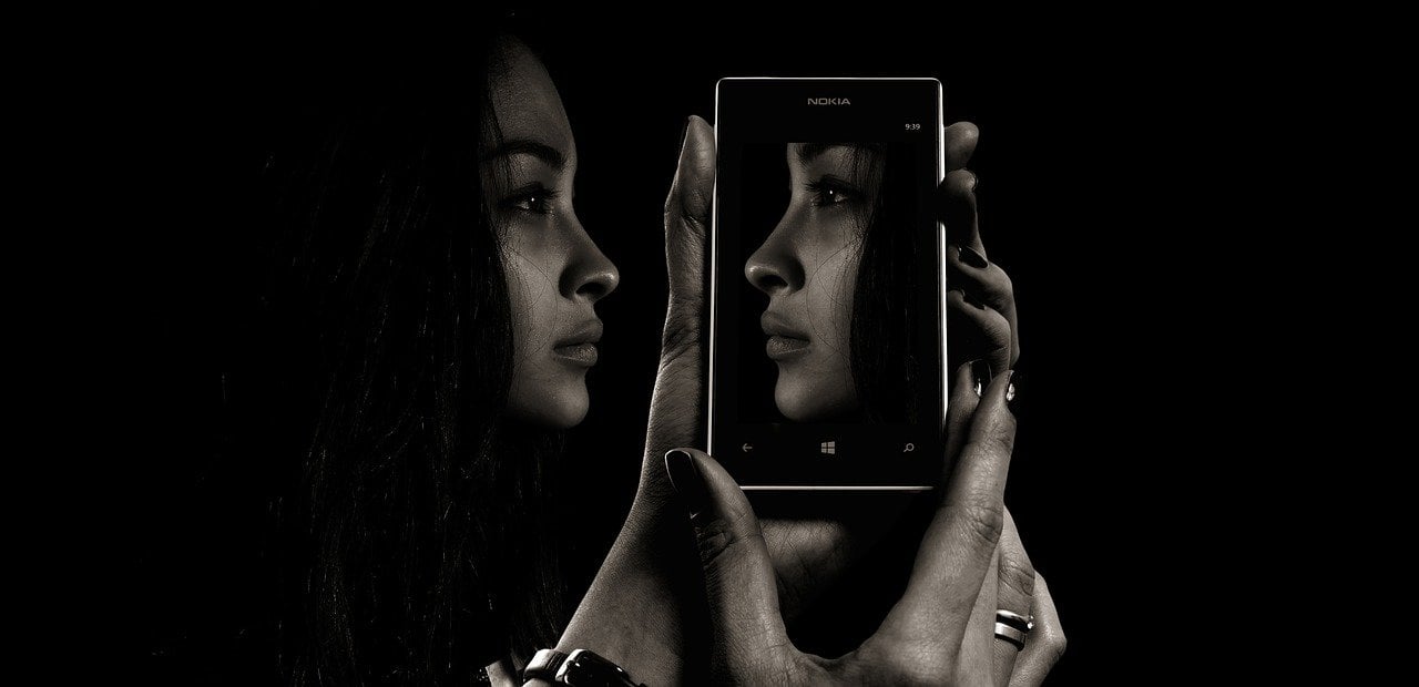 Woman's Reflection in Phone by Gerd Altmann from Pixabay.